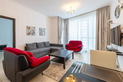 a living room with a couch and a table at 1BD apartment in Torch Tower, Dubai Marina in Dubai