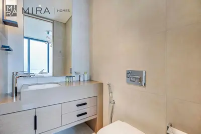 a bathroom with a sink and a mirror at Mira Holiday Homes - Lovely 2 BDR with Sea View in Dubai