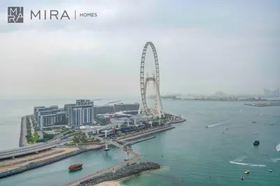 an aerial view of a city with a ferris wheel at Mira Holiday Homes - Lovely 2 BDR with Sea View in Dubai