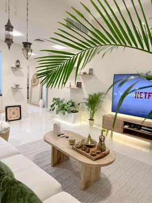 a living room with a coffee table and a tv at Arabian-Inspired 1BR - Polo Residence Near Burj in Dubai