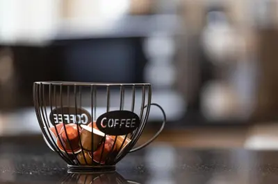 a coffee cup sitting on top of a table at Arabian-Inspired 1BR - Polo Residence Near Burj in Dubai