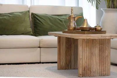 a coffee table in a living room with a couch at Arabian-Inspired 1BR - Polo Residence Near Burj in Dubai