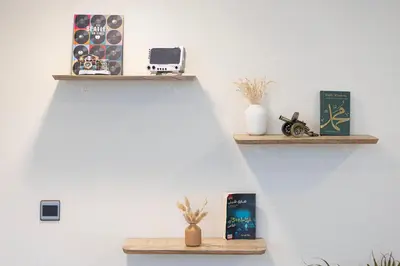 a wall with two wooden shelves with books at Arabian-Inspired 1BR - Polo Residence Near Burj in Dubai