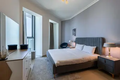 a bedroom with a bed and a desk and window at 2BDR apartment near Burj Khalifa I Downtown Dubai I Burj Vista in Dubai