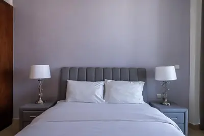 a bedroom with a bed with two lamps on tables at 2BDR apartment near Burj Khalifa I Downtown Dubai I Burj Vista in Dubai