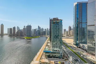a view of a city with a river and buildings at Livin' Holidays - Luxury studio with Bay view in Dubai