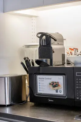 a microwave sitting on top of a kitchen counter at Livin' Holidays - Luxury studio with Bay view in Dubai