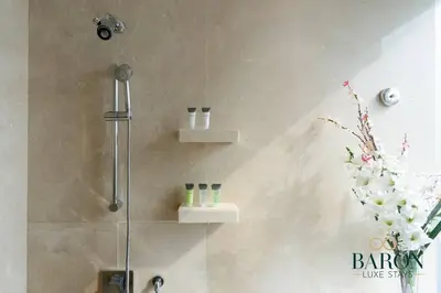 a bathroom with a shower with a glass door at The Regal in Dubai