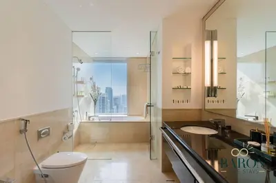 a bathroom with a shower and a toilet and a sink at The Regal in Dubai