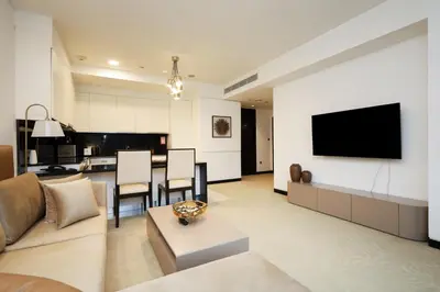 a living room with a couch and a tv on a wall at Luxury Marina View Apartment in JW Marriott Residences in Dubai