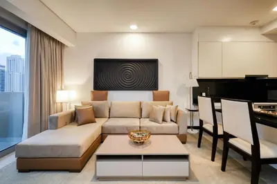 a living room with a couch and a table at Luxury Marina View Apartment in JW Marriott Residences in Dubai