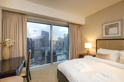 a hotel room with a bed and a large window at Luxury Marina View Apartment in JW Marriott Residences in Dubai