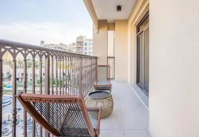 a balcony with two chairs and a table at Vacay Lettings 2 Bed Retreat near Burj Al Arab in Dubai