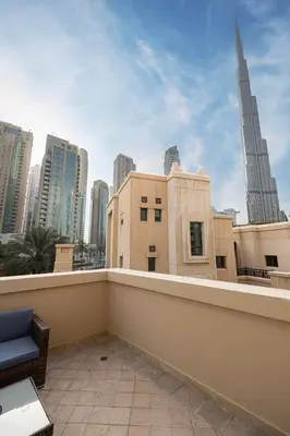 a balcony with a view of a city skyline at Old Town Luxury: 1-BR Apartment with Large Terrace & Burj Khalifa View in Dubai