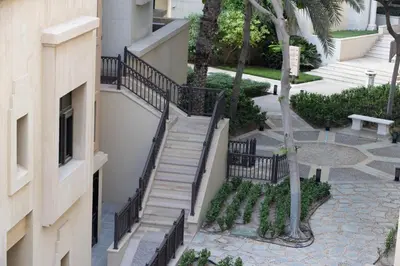 a staircase leading up to a building at Old Town Luxury: 1-BR Apartment with Large Terrace & Burj Khalifa View in Dubai