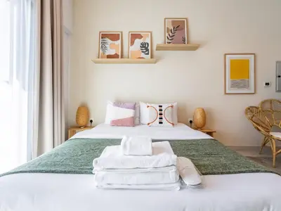 a bedroom with a bed with towels on it at Charming Studio Escape With Unobstructed City View in Dubai
