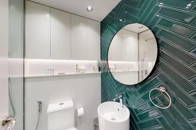 a bathroom with a sink and a mirror at Shiny & Fresh - Studio with Lake View - JLT in Dubai