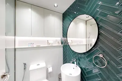 a bathroom with a sink and a mirror at Shiny & Fresh - Studio with Lake View - JLT in Dubai