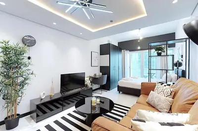 a living room with a couch and a bed at Earthy & Sharp - Studio with Lake View - JLT in Dubai