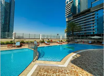 a large swimming pool in a resort with buildings at Earthy & Sharp - Studio with Lake View - JLT in Dubai