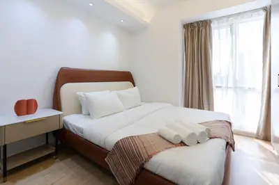 a bedroom with a bed with two towels on it at Airy and Peaceful - Studio - JLT in Dubai