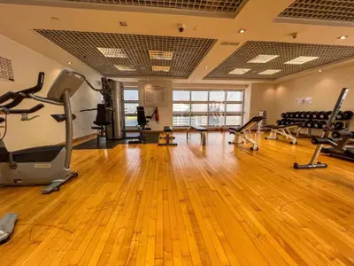 a gym with treadmills and exercise equipment in a room at Airy and Peaceful - Studio - JLT in Dubai