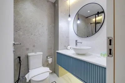 a bathroom with a toilet and a sink and a mirror at Bright and cozy - Studio - JLT in Dubai
