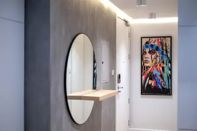 a bathroom with a mirror and a painting on the wall at Bright and cozy - Studio - JLT in Dubai