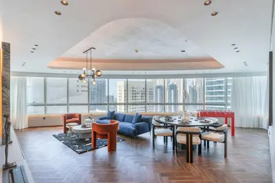 a living room with a blue couch and a table at Fully Furnished 4 BR in Dubai Marina - Very close to Metro in Dubai