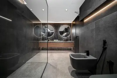 a bathroom with a sink and a toilet and mirrors at Luxury Duplex - 2 BR - Dubai Marina JBR in Dubai