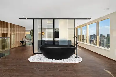 a large black bath tub in a room with windows at Luxury Duplex - 2 BR - Dubai Marina JBR in Dubai