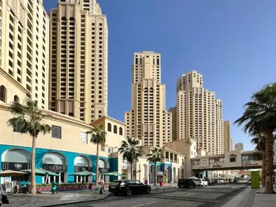 a city street with palm trees and tall buildings at Luxury Duplex - 2 BR - Dubai Marina JBR in Dubai