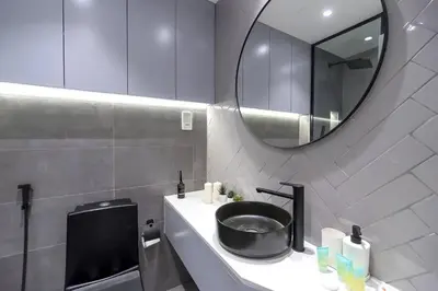 a bathroom with a black sink and a mirror at Classy and Bright - Studio - JLT in Dubai
