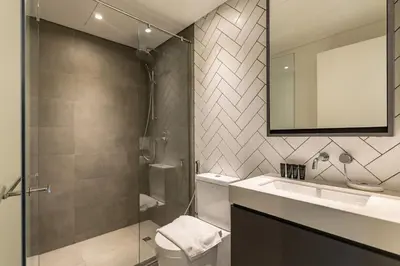 a bathroom with a toilet and a sink and a mirror at Belgravia T2,JVC - 2BR Duplex Apartment - Allsopp&Allsopp in Dubai