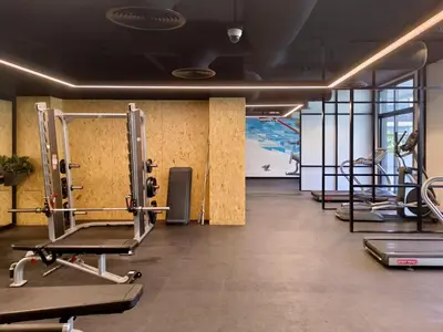a gym with several tread machines in a room at Belgravia T2,JVC - 2BR Duplex Apartment - Allsopp&Allsopp in Dubai
