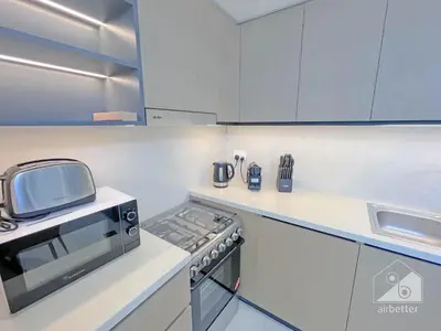 a kitchen with a stove and a microwave at Burj Crown Luxury 2-Bedroom with Balcony in Dubai
