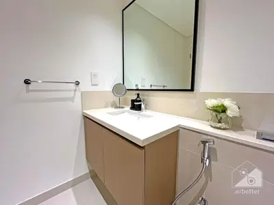 a bathroom with a sink and a mirror at Burj Crown Luxury 2-Bedroom with Balcony in Dubai