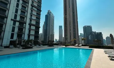 a swimming pool in the middle of a city with tall buildings at Burj Crown Luxury 2-Bedroom with Balcony in Dubai