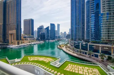 a view of a river in a city with tall buildings at Lavish 2BR with Charming Marina View in Dubai