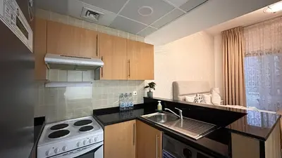 a kitchen with a sink and a stove at Spontaneous Sea View and High floor Studio Apartment in Dubai