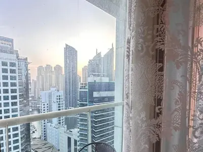 a view of a city skyline from a window at Spontaneous Sea View and High floor Studio Apartment in Dubai