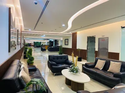 a lobby with couches and tables in a hospital at Spontaneous Sea View and High floor Studio Apartment in Dubai