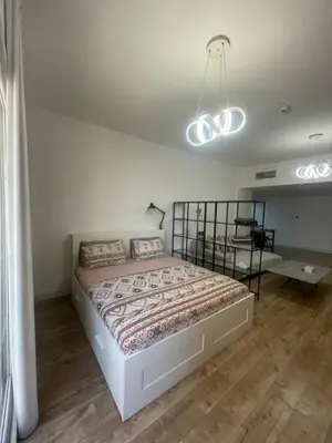 a bedroom with a large bed and a table at A chilled place JVC in Dubai