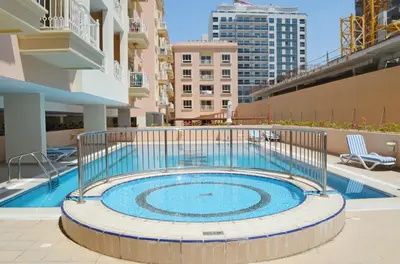 a swimming pool in the middle of a building at A chilled place JVC in Dubai