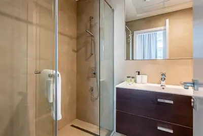 a bathroom with a sink and a shower at Spacious apartment with Maid room in Dubai Marina I Marina Arcade in Dubai