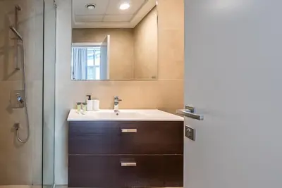 a bathroom with a sink and a mirror at Spacious apartment with Maid room in Dubai Marina I Marina Arcade in Dubai
