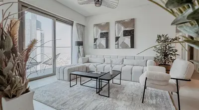 a living room with a white couch and a table at Burj Crown Luxury 2bedroom Balcony & View in Dubai