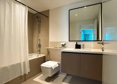 a bathroom with a sink toilet and a mirror at Burj Crown Luxury 2bedroom Balcony & View in Dubai