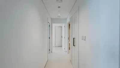 an empty hallway with white walls and white ceilings at Burj Crown Luxury 2bedroom Balcony & View in Dubai