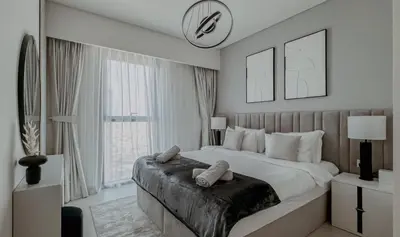 a bedroom with a large bed and a large window at Burj Crown Luxury 2bedroom Balcony & View in Dubai